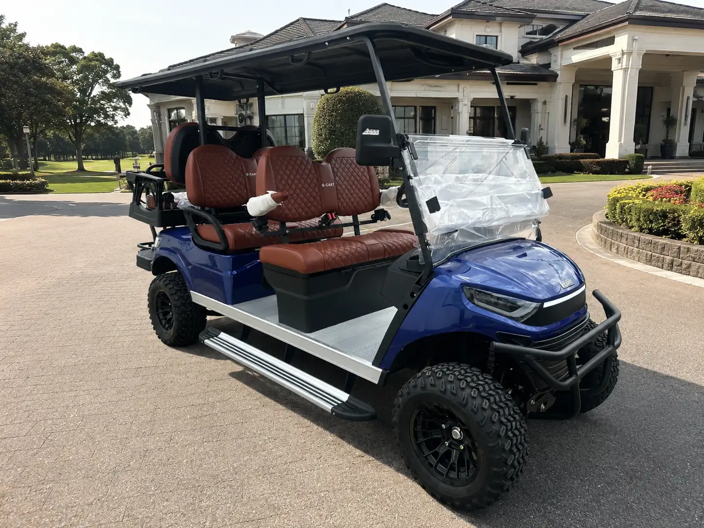 Blue G-CART A2 lifted six-seater outside the clubhouse